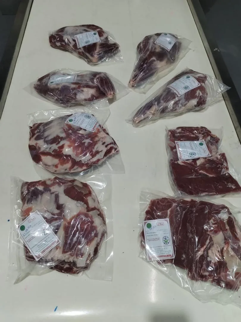 Vacuum-packed meat cuts on a processing table